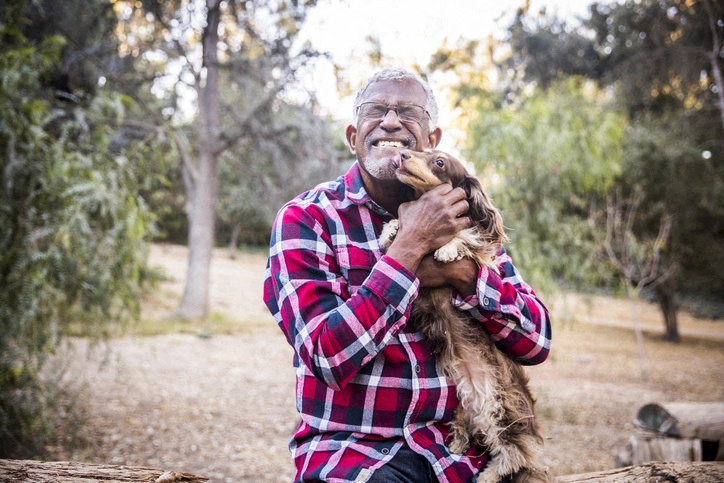 elderly man with dog outside